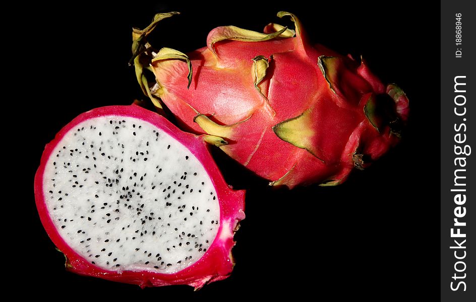 The fresh fire dragon fruit takes in the black background.