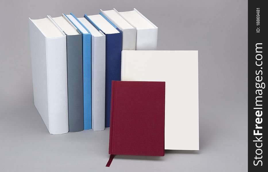 Plain books, white, blue and red