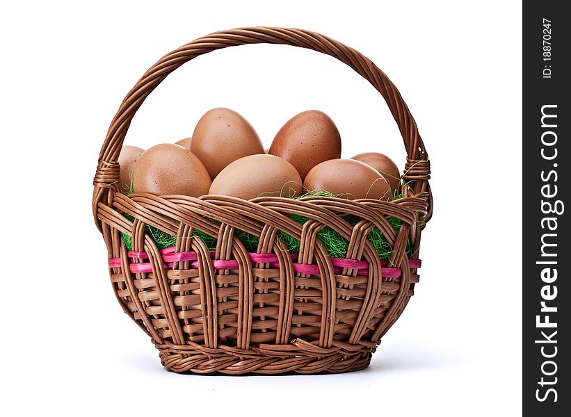 Woven basket full of eggs. Isolated on a white background. Woven basket full of eggs. Isolated on a white background.