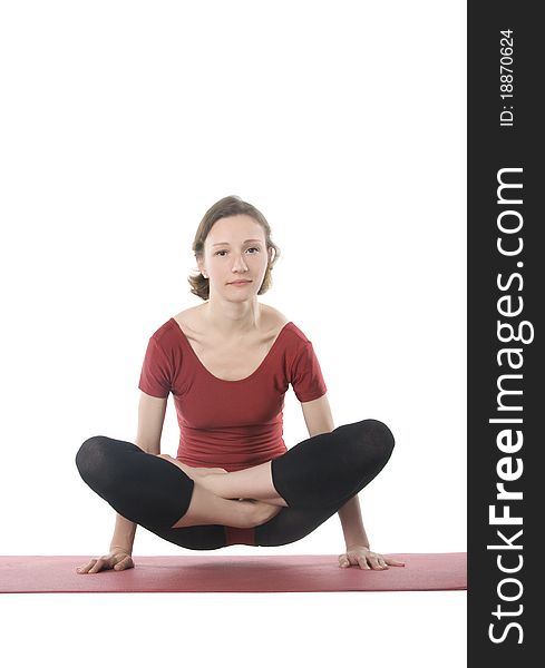 Woman exercising on a mat over white background. Woman exercising on a mat over white background