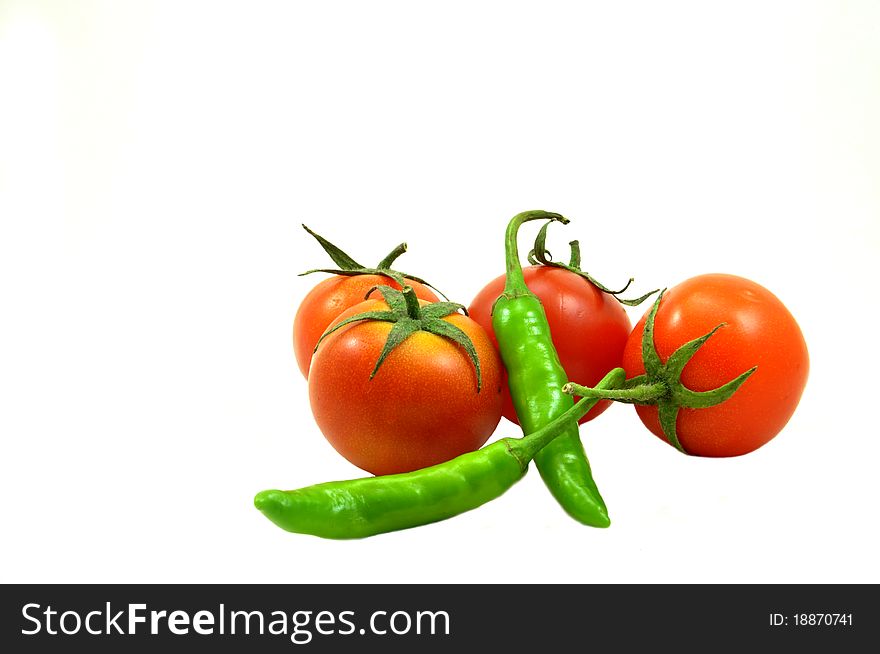 Tomatoes and chillies isolated on white background