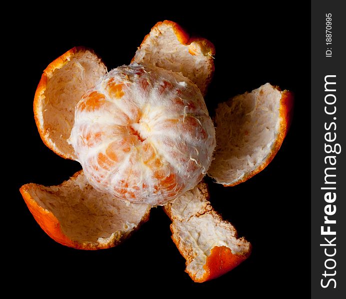 Single peeled mandarin on black background