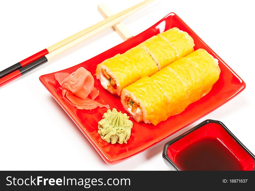 Yellow sushi rolls served on a plate. Isolated on white background