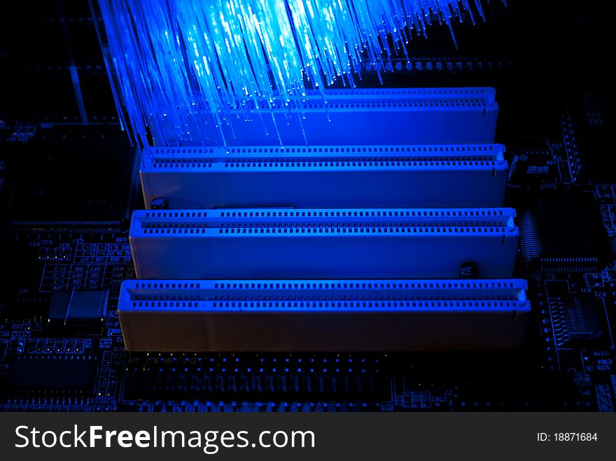 Photo of computer motherboard with fiber optics background. Photo of computer motherboard with fiber optics background