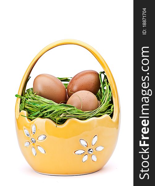 Woven basket full of eggs. Isolated on a white background. Woven basket full of eggs. Isolated on a white background.