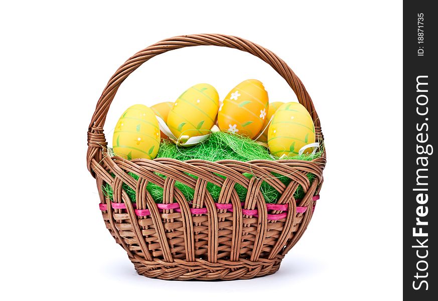 Woven basket full of eggs. Isolated on a white background. Woven basket full of eggs. Isolated on a white background.