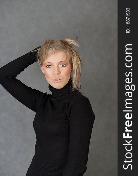 Portrait of blond woman on gray background