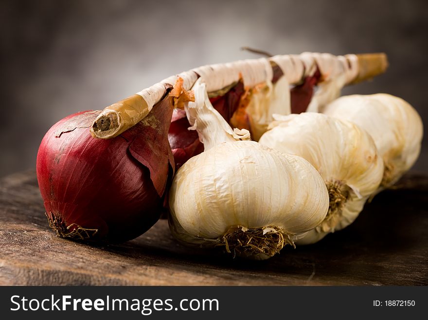 Photo of onion and garlic on wooden table