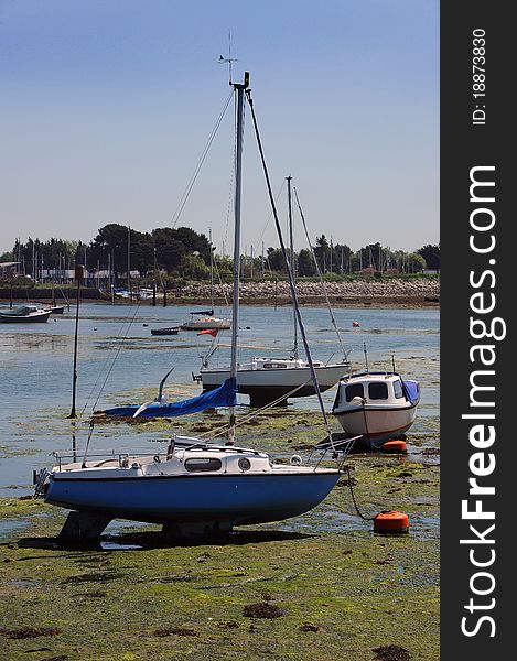 Yachts on the mud at low tide.