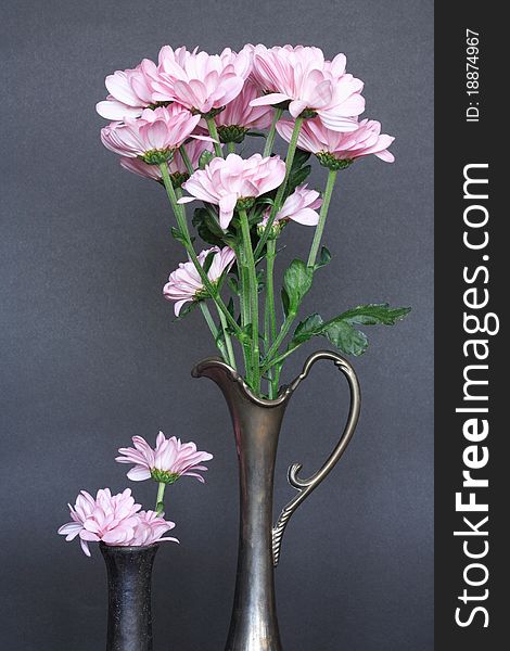 Two ancient vases with nice pink flowers on dark background. Two ancient vases with nice pink flowers on dark background