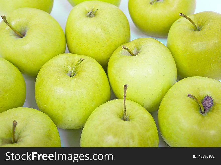 Green and yellow apples on a white background isolated