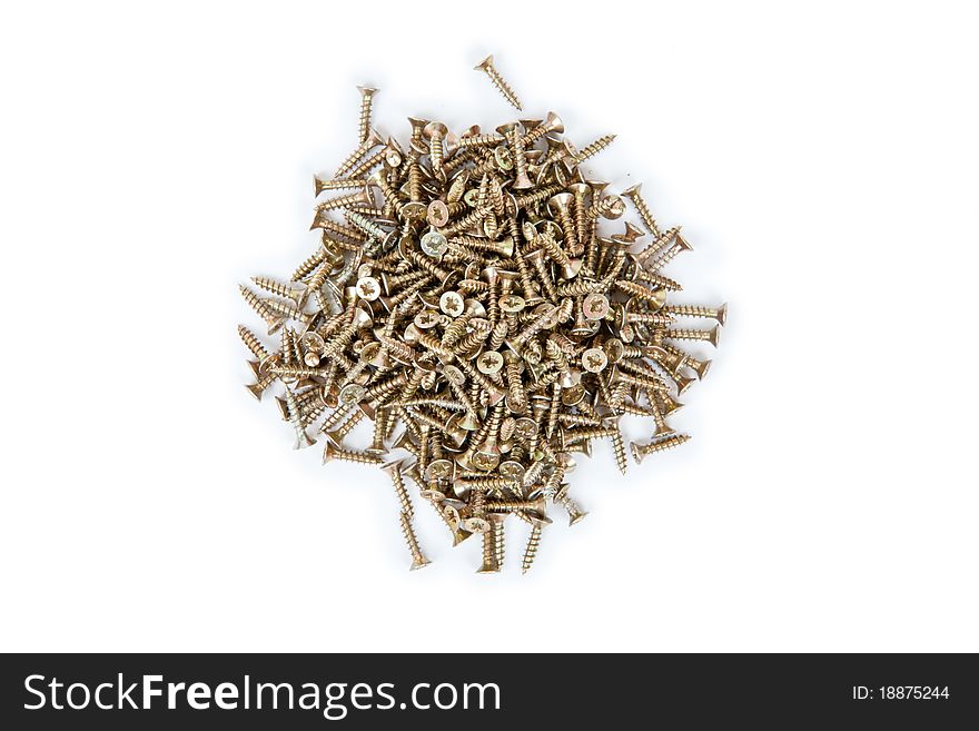 Many small brass self-atack screws isolated on white background
