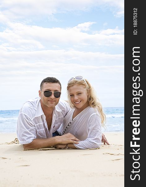 Portrait of young nice couple having good time on the beach. Portrait of young nice couple having good time on the beach