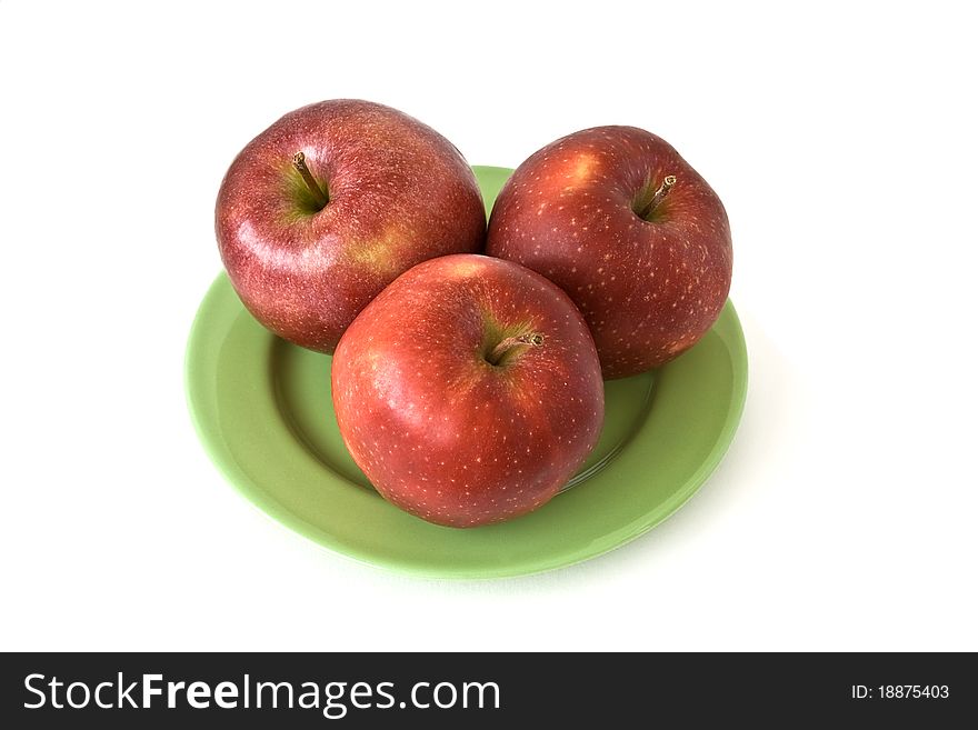 Three colored apples on wicker plate at the table. Three colored apples on wicker plate at the table