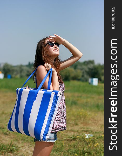 Caucasian young woman with beach bag, summer vacations. Caucasian young woman with beach bag, summer vacations