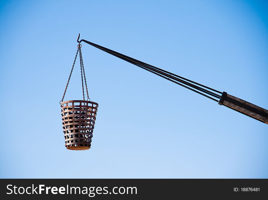 A basket hanging on a hook. A basket hanging on a hook