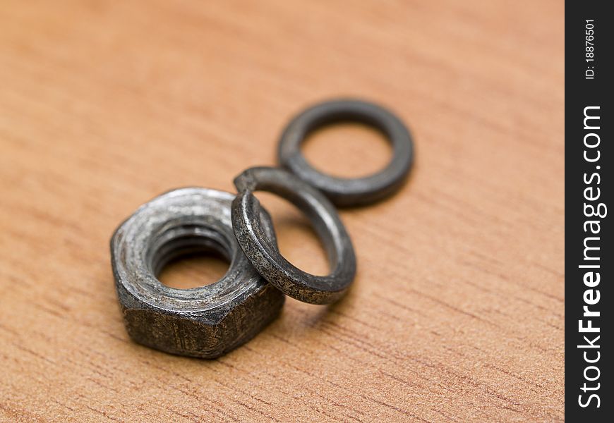 Nut and washer on a wooden table