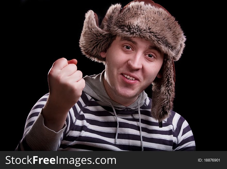 Man in a striped sweater in a fur hat