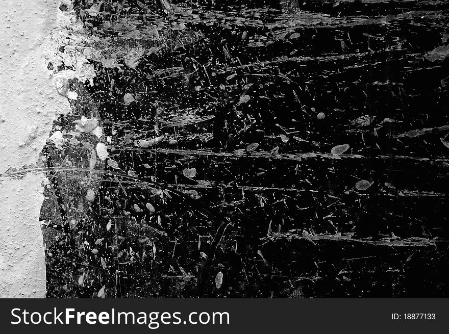 A dark concrete wall with paint splashes as a background. A dark concrete wall with paint splashes as a background