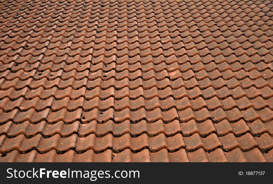 Roof of a house covered with old red tiling