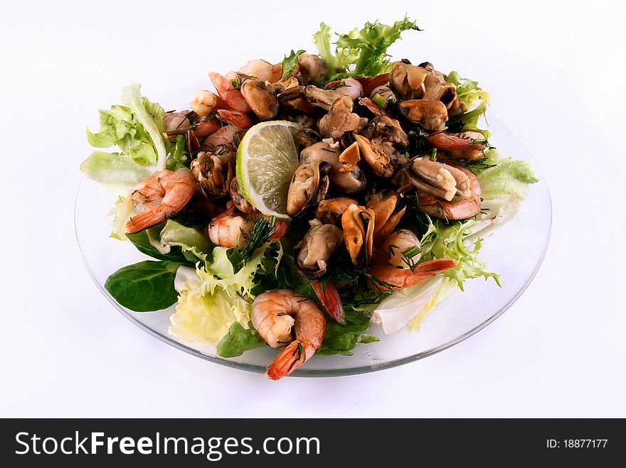 A Salad With Seafood On A Glass Plate