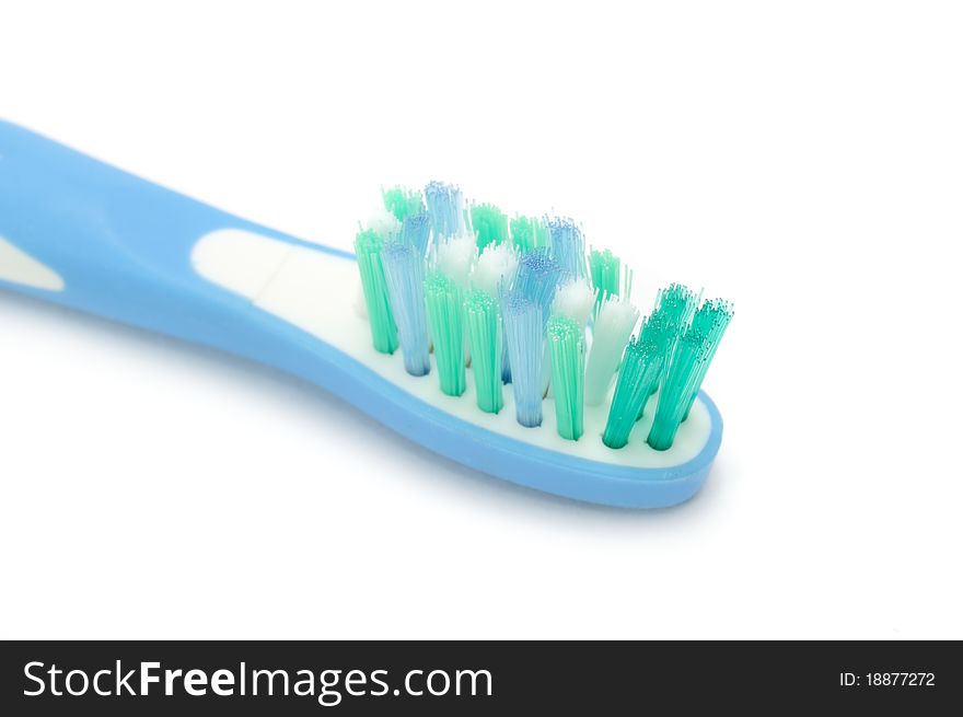 A close-up of an electric toothbrush on a white background. A close-up of an electric toothbrush on a white background