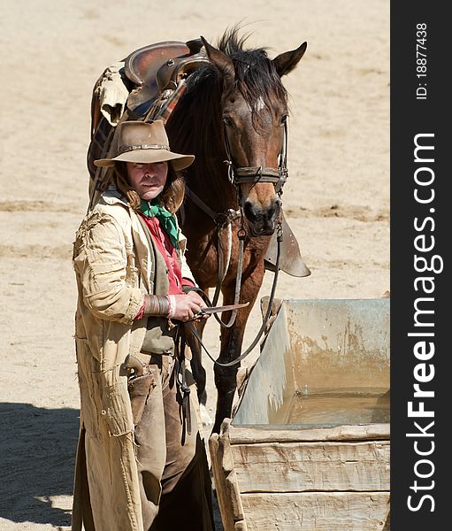 Cowboy and his horse at a water trough at Mini Hollywood, Almeria, Andalusia, Spain