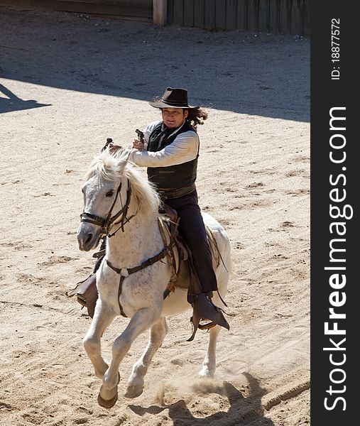 Deputy Sheriff shooting his pistol on horseback at Mini Hollywood, Almeria, Andalusia, Spain