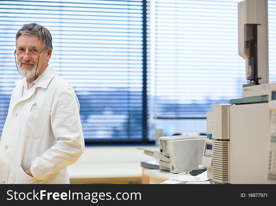 Renowned scientist/doctor in a research center/hospital laboratory looking confident (color toned image; shallow DOF)