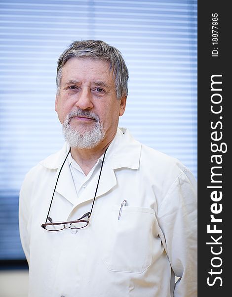 Renowned scientist/doctor in a research center/hospital laboratory looking confident (color toned image; shallow DOF)