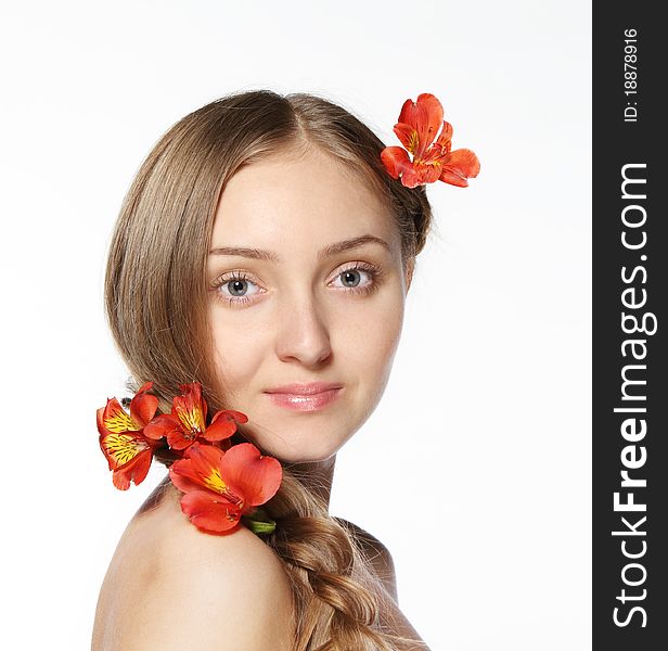 Portrait of the beauty young blond girl with lily in her hair