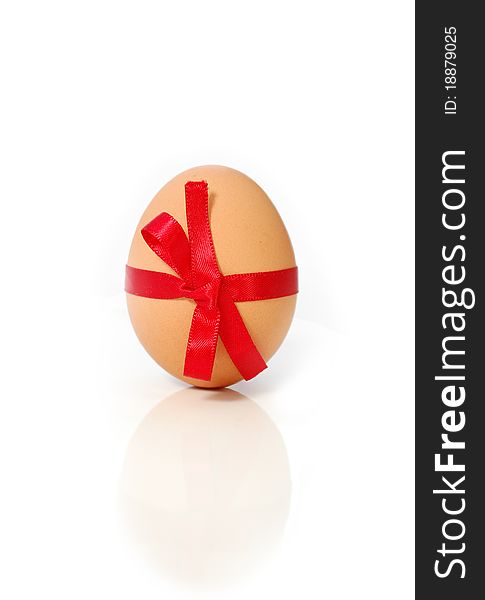 Brown easter egg wrapped with a ribbon bow