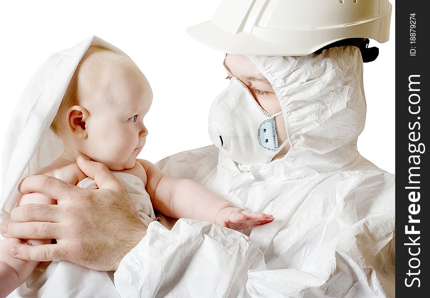 The man in protective clothes and a respirator holds the baby on hands. The man in protective clothes and a respirator holds the baby on hands