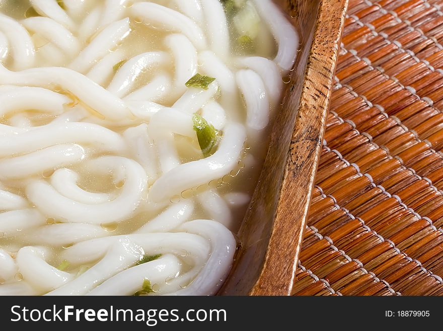 Asian noodle soup in a brown wooden bowl. Asian noodle soup in a brown wooden bowl.