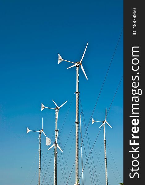 Turbine wind mills on blue sky background