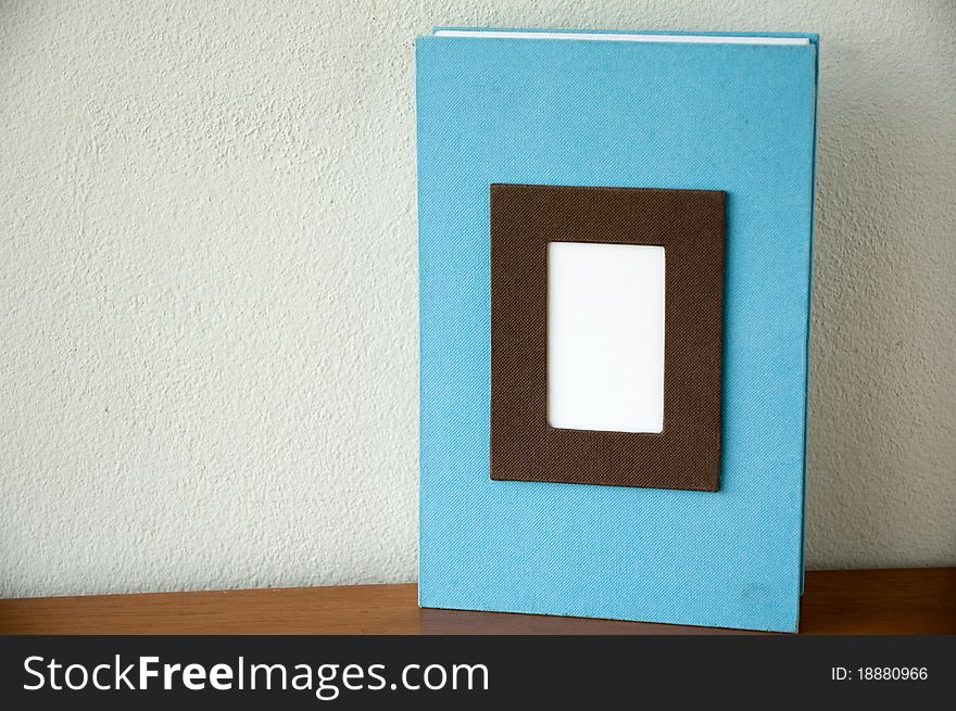 Blue notebook with empty white space in front put on wooden desk. Blue notebook with empty white space in front put on wooden desk.