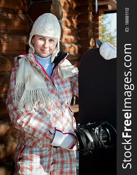 Happy young boarder girl with a snowboard in a ski resort. Happy young boarder girl with a snowboard in a ski resort