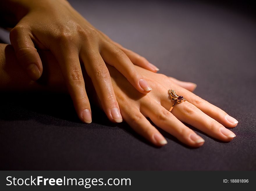 Woman's hand with a ring on his finger on the table
