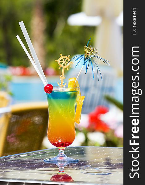 View of a colorful four-layered cocktail. View of a colorful four-layered cocktail