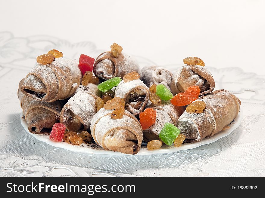 House cookies with raisin and sweets in a plate on a light background. House cookies with raisin and sweets in a plate on a light background