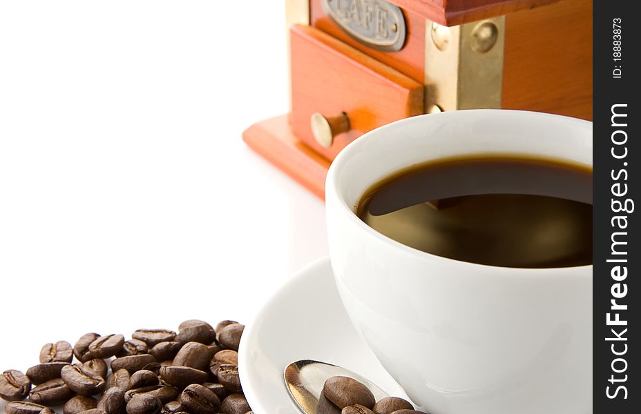 Cup of coffee, grinder and beans on white