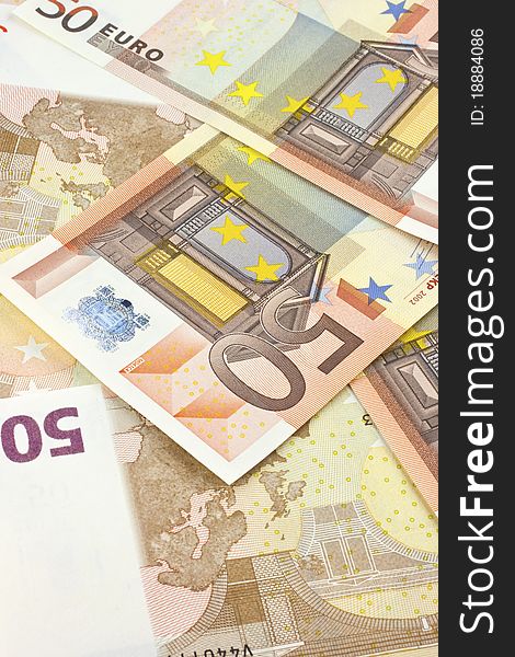 Background of scattered 50-euro banknotes.