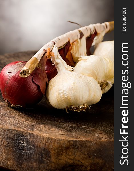 Photo of onion and garlic on wooden table