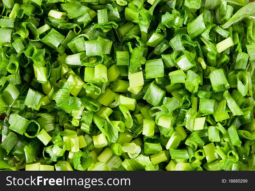 Chopped green spring onions background. Chopped green spring onions background