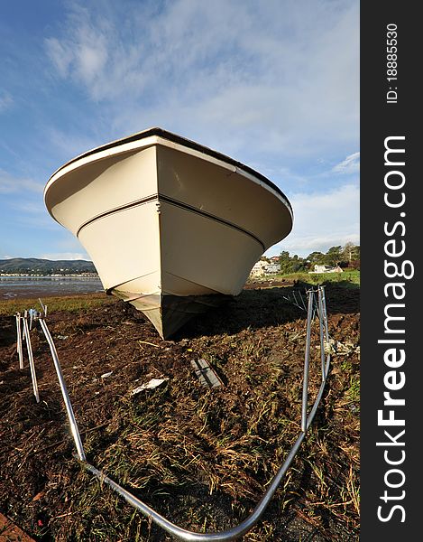 A boat is ashore after a storm shipwrecked it. A boat is ashore after a storm shipwrecked it