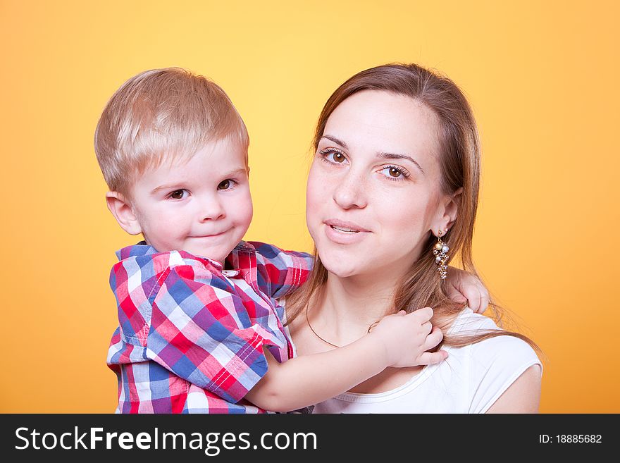 Closeup portrait of little boy embracing his smiling mother