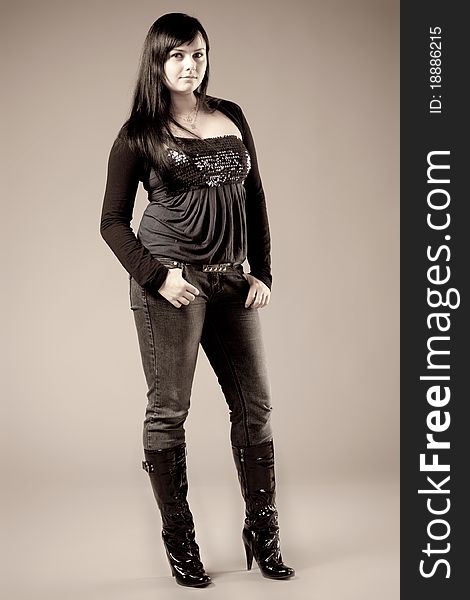 Girl in jeans and boots. Posing