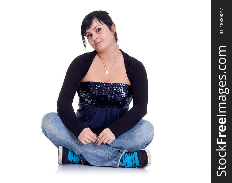 Girl in jeans sitting in the lotus position on white background