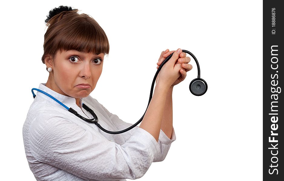 Beautiful young woman doctor with a stethoscope sings on a white background