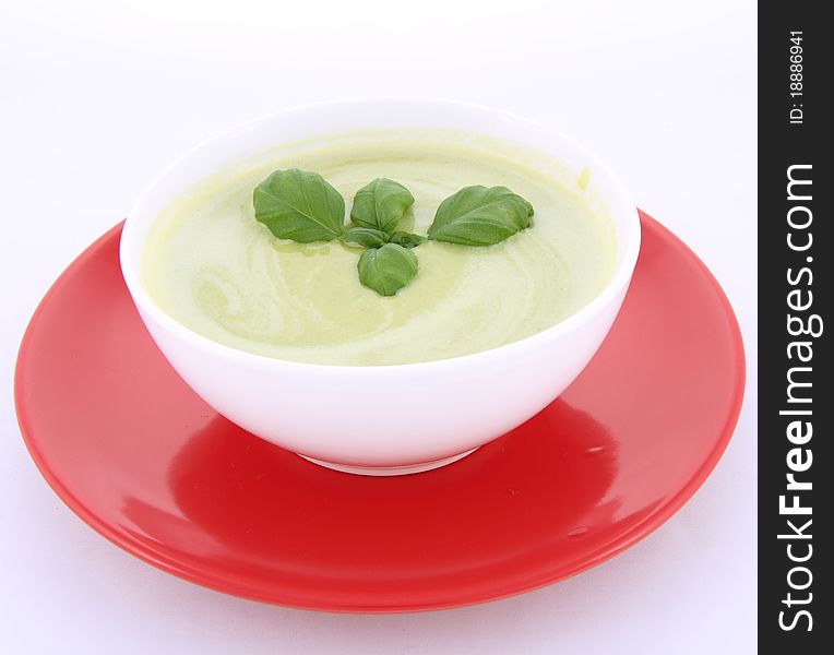 Pea and mozzarella soup decorated with basil